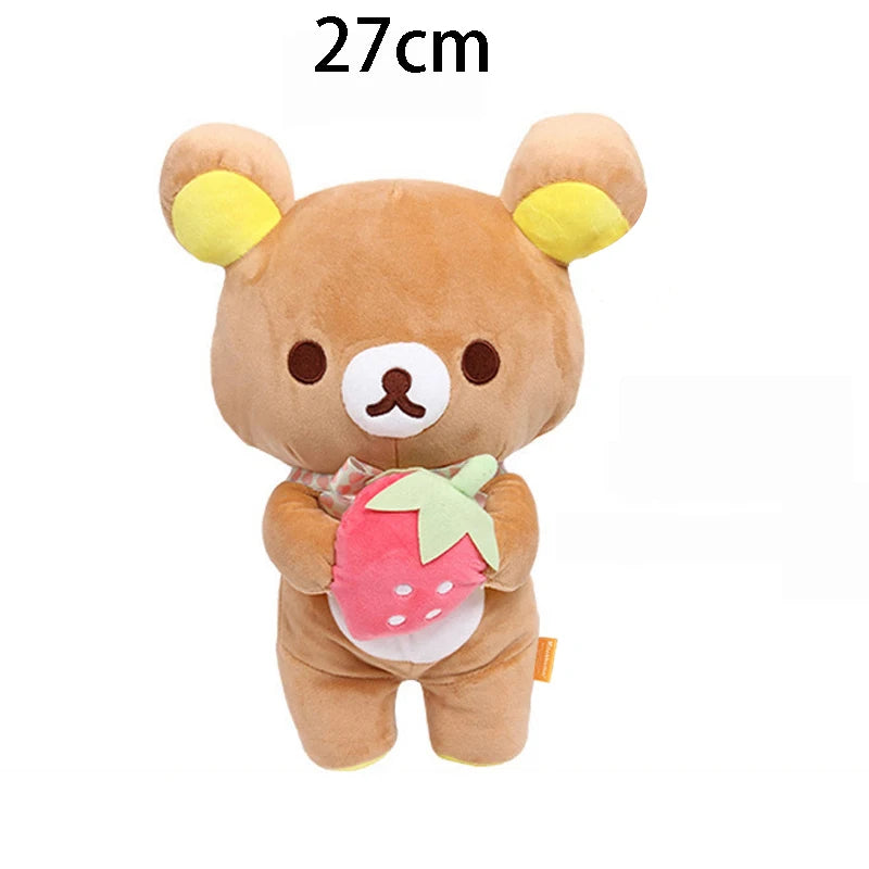 A brown Rilakkuma anime plush bear with yellow ears and a pink strawberry accessory.