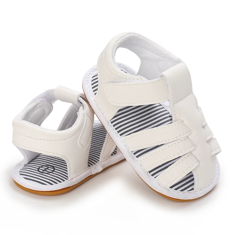 A pair of white breathable baby first walker sandals with a soft anti-slip sole.