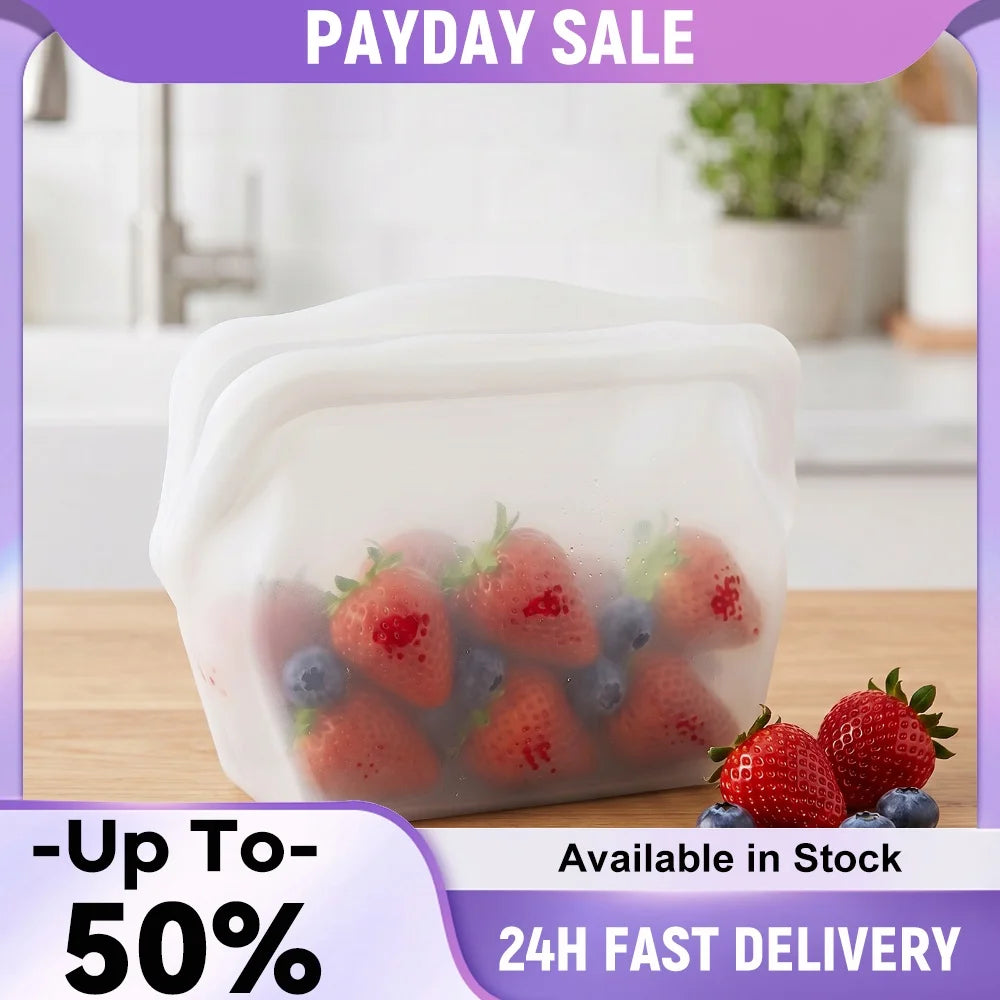 Clear silicone storage bag filled with fresh strawberries and blueberries on a wooden surface.