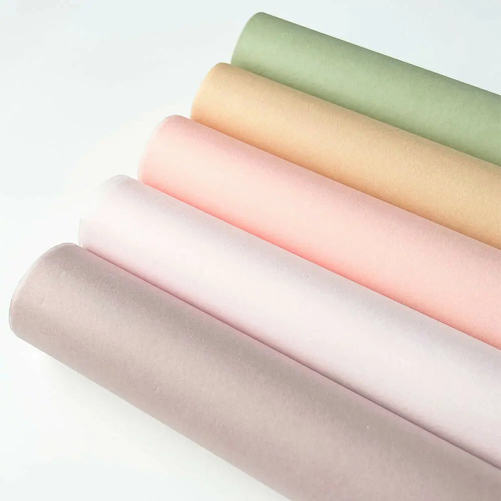 A stack of twenty tissue paper sheets in pastel shades, including pink, peach, and green.