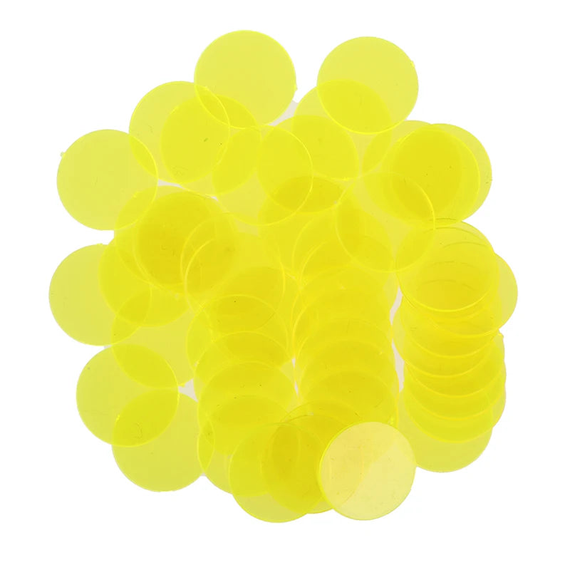 A pile of bright yellow plastic bingo chips for games and family fun