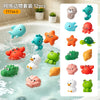 A set of 12 colorful water squirting turtle bath toys floating in a bathtub.
