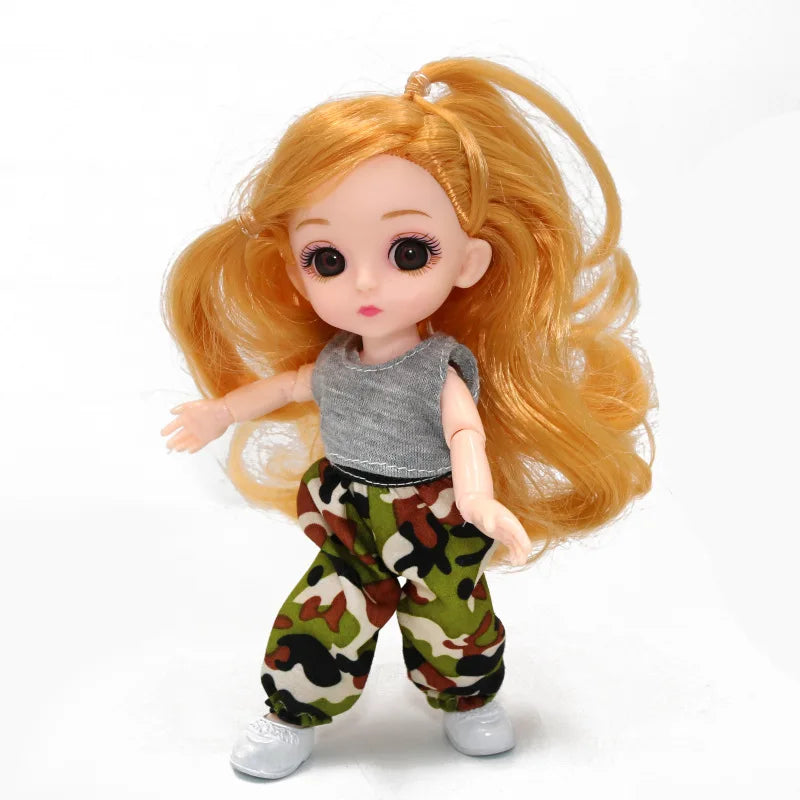 An articulated ball-jointed doll with long orange hair wearing a gray top and camouflage pants.