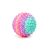 A spherical fidget roller keychain with a textured, multi-colored surface featuring pink, purple, and teal patterns.
