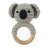 A gray knitted elephant rattle and teether ring made of soft yarn attached to a wooden loop.