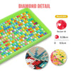 A diamond painting kit showing colorful mosaic dots on a green canvas with a round drill and sample patterns.