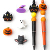 A collection of Halloween silicone beads including a purple bat, orange pumpkin, white ghost, and black bat silhouette.