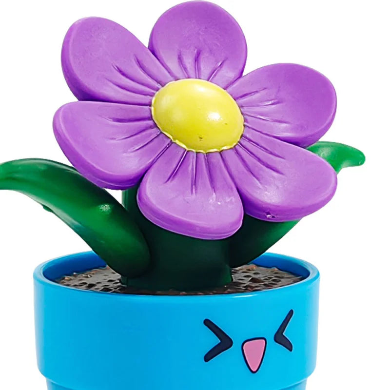 A purple flower with a yellow center is growing out of a green stem in a blue pot.