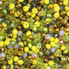Multicolor round crystal glass beads in shades of yellow, green, and amber for jewelry making