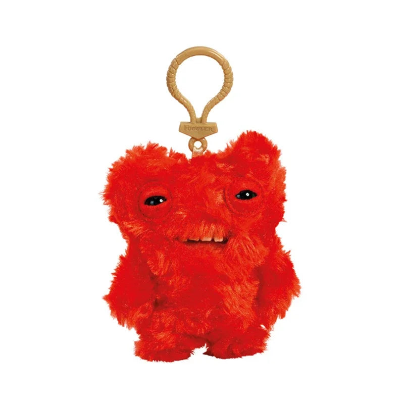 A bright red Fuggler plush monster keychain with a quirky rabbit design.