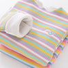 A striped cotton shirt with pink, yellow, and blue stripes and a small rainbow detail.