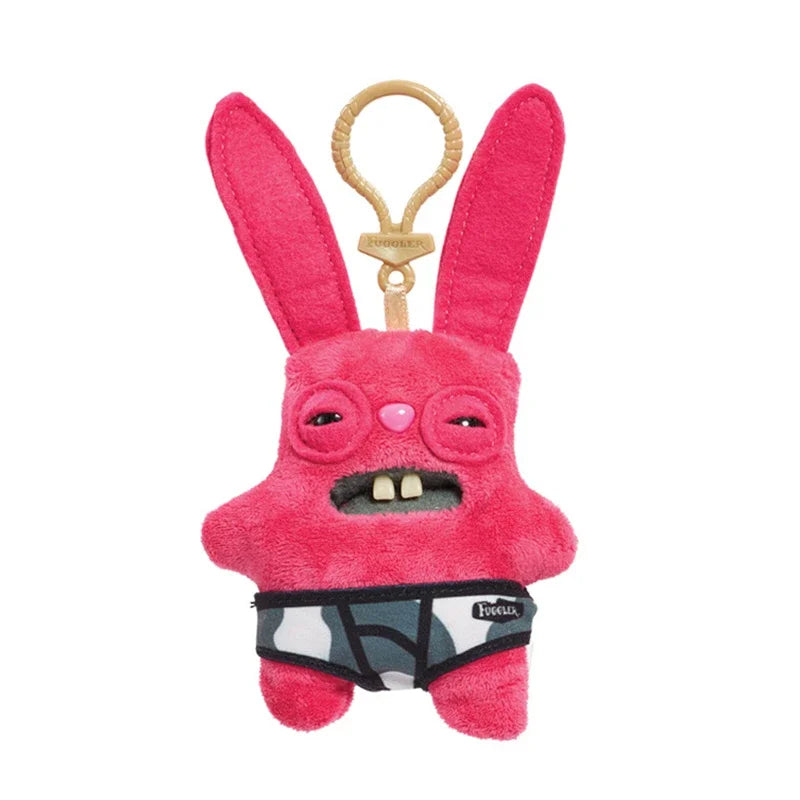 A pink plush rabbit monster keychain with a stitched face and black patterned underwear.