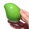 A hand holds a bright lime green stress ball shaped like an oval.