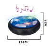 A blue glowing LED hover soccer ball resting on a black base with musical notes above it.