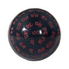 A close-up view of a dark blue 100-sided polyhedral die with red numbers and markings.