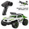 A black remote control for a Super Power Track off-road car and the green and white RC monster truck model.