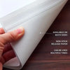 A hand holds a sheet of non-stick release paper available on both sides for diamond painting projects.