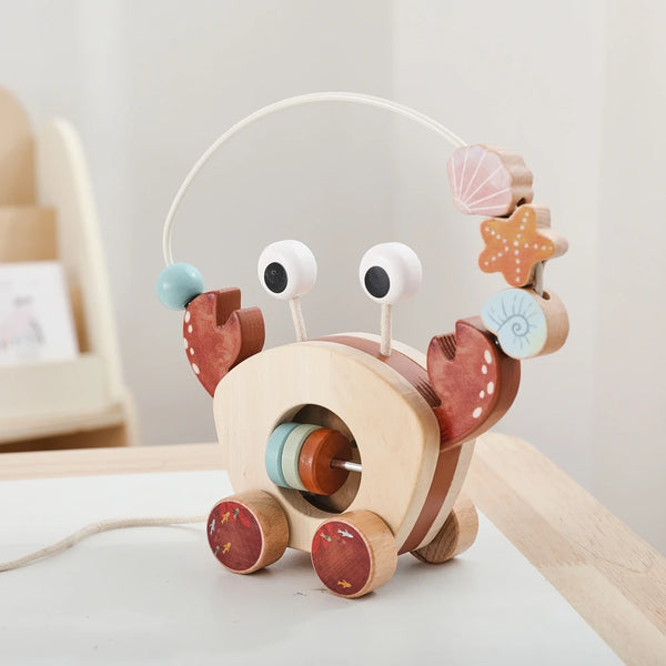 Montessori wooden crab drag toys featuring a wooden body and a wire handle with decorative wooden claws.