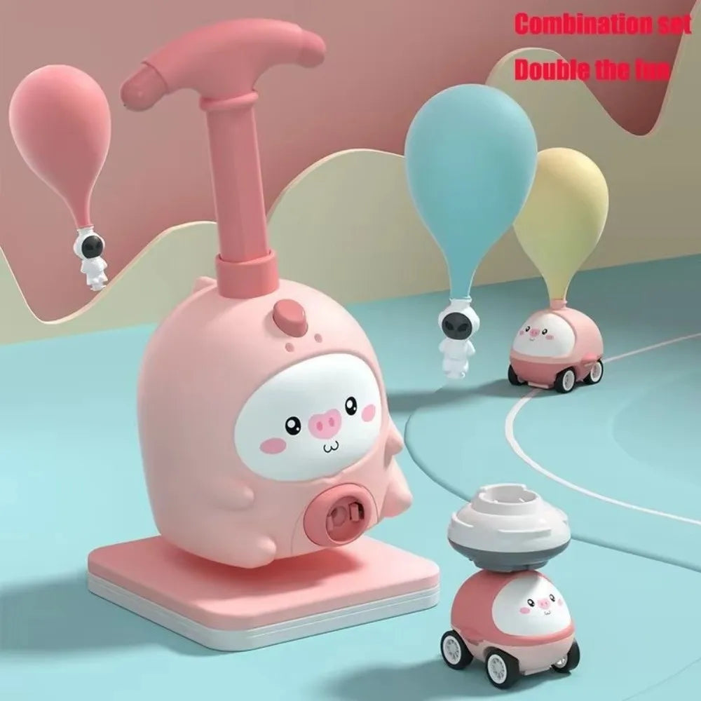 A pink balloon-powered racing car toy set featuring a launcher and a small car model.