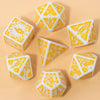 A collection of seven white and orange fantasy carved polyhedral dice set for tabletop role-playing games