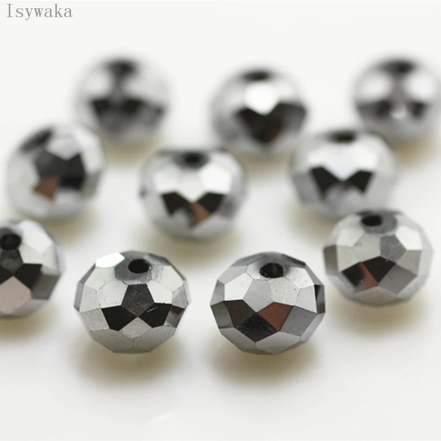 A collection of silver-toned crystal glass beads and round spacers for jewelry making