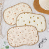 A set of three beige and cream 10-layer cotton gauze flat pillows with small embroidered animal patterns.