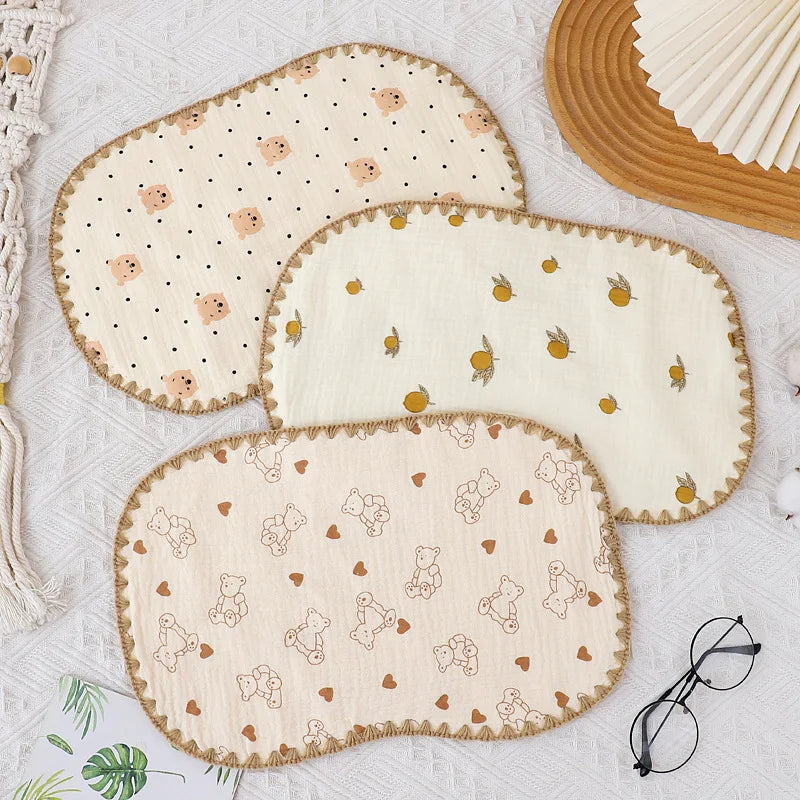 A set of three beige and cream 10-layer cotton gauze flat pillows with small embroidered animal patterns.