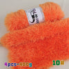 Orange chunky faux fur yarn in a skein and a ball, used for knitting projects.