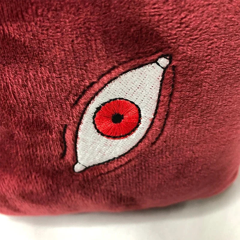 A close-up of a Jujutsu Kaisen Prison Realm Gojo plush figure with an eye design.
