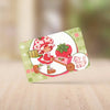 A set of four cartoon stickers featuring Strawberry Shortcake characters on a green card background.