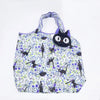 A white fabric tote bag featuring a pattern of black cats and purple flowers.