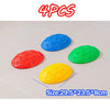 Four colorful balance stones in red, yellow, and green are displayed on a white surface.