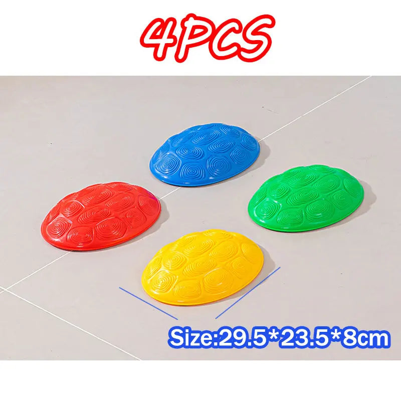 Four colorful balance stones in red, yellow, and green are displayed on a white surface.