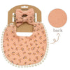 A pink floral baby bib and headband set with a bow, presented on a brown card.