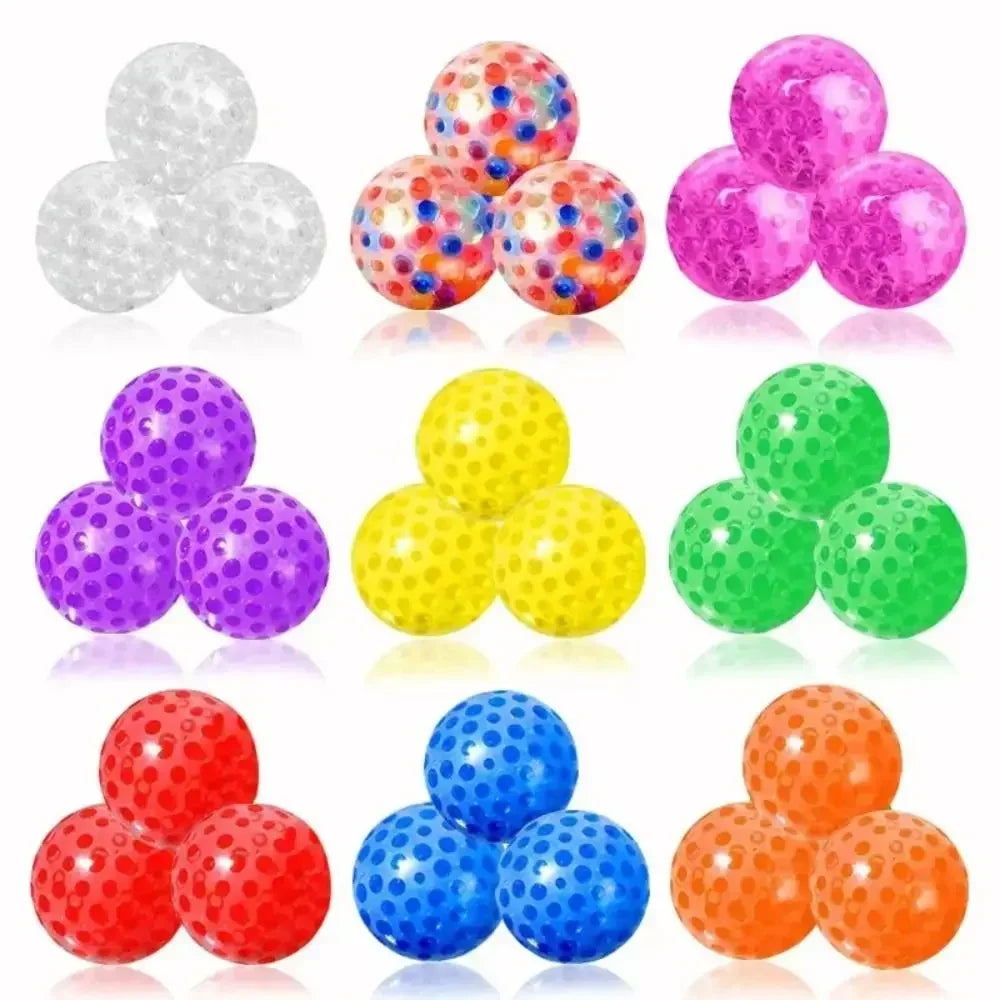 A collection of colorful water bead stress balls in various bright colors including purple, yellow, green, and red.