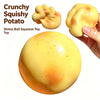 A yellow squishy potato stress ball toy shown in various forms and being squeezed by a hand.