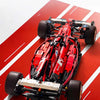 A red 1:8 scale open-wheel racing car building kit with wheels and chassis components displayed on a red background.