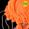 Close-up of an orange, fluffy jellyfish plush toy with white strings and a sheer ribbon detail.