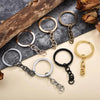 A collection of gold and silver geometric silicone mold sets for epoxy resin earrings and pendants displayed on a neutral sur