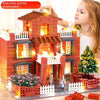A young girl is building a brick and tile construction model of a house with miniature figures.