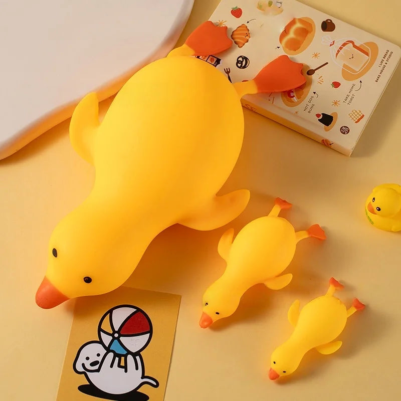 A bright yellow jumbo squishy duck stress ball fidget toy resting on a light background.