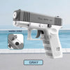 A gray tactical water blaster pistol is shown with a close-up of the water inlet and a side view.