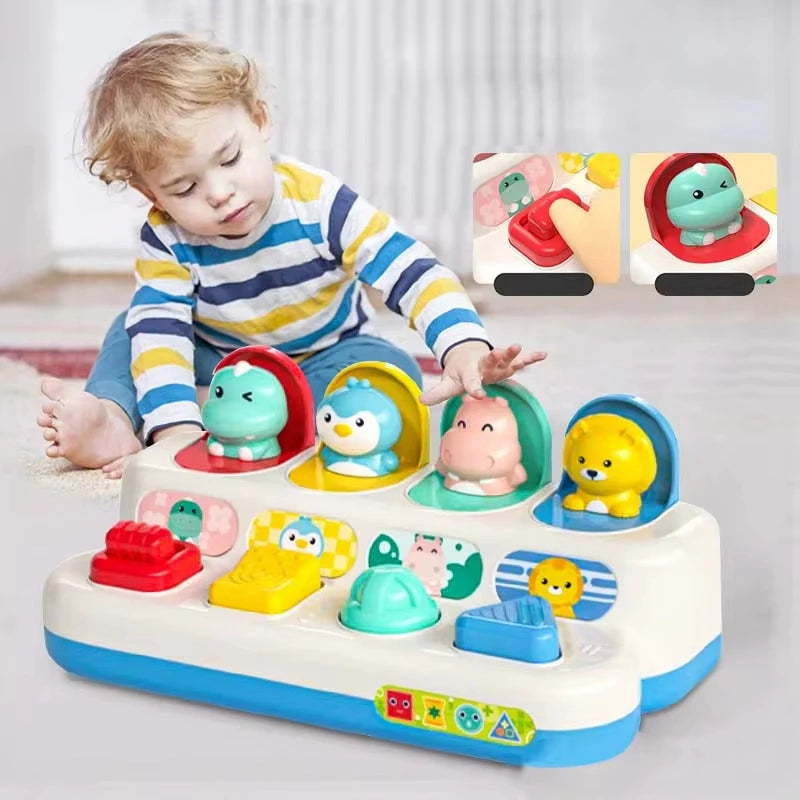 A child is playing with a colorful peekaboo pop-up animal toy featuring various animals and cause and effect learning element