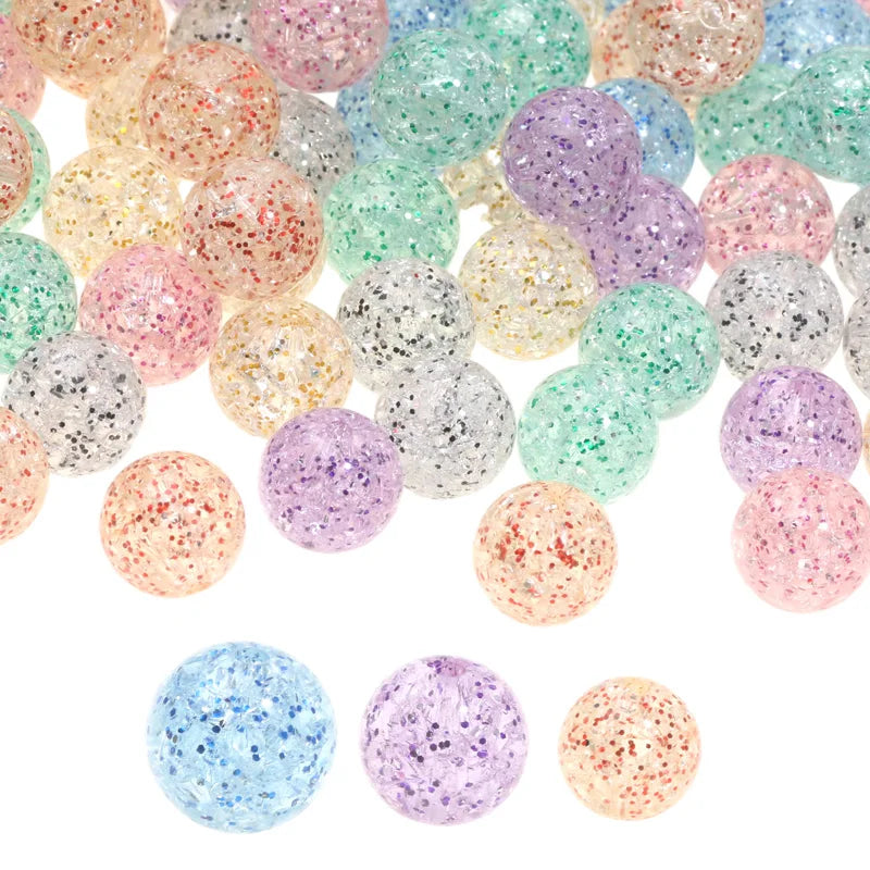 A collection of round glitter cracked acrylic beads in various colors including pink, purple, green, and gold.
