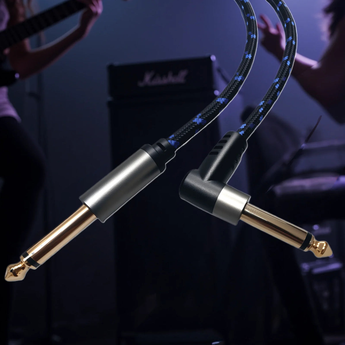 A close-up of a black instrument cable with a gold connector, being handled by a musician in a dark setting.