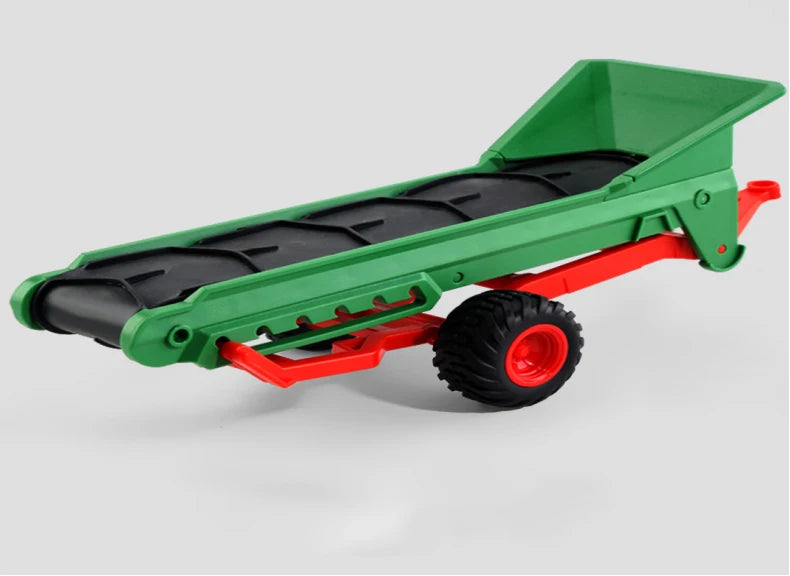 A green remote control tractor with a trailer is shown from the side.