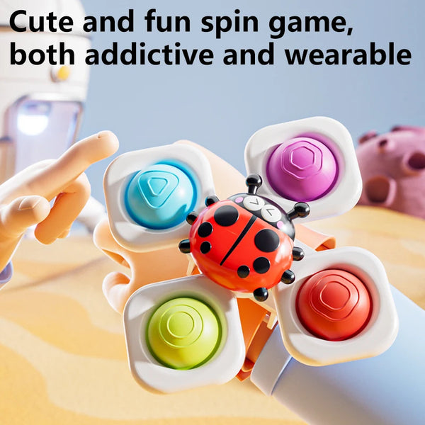Three colorful spinning top fidget toys with watch bands being spun by a hand.