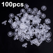 A pile of 100 clear silicone earring backs for secure stud closure.