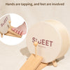 A wooden musical toy featuring a drum set where hands and feet are involved for play.