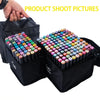 A hand is holding a black pouch containing a large set of colorful dual-tip alcohol art markers for sketching and manga.
